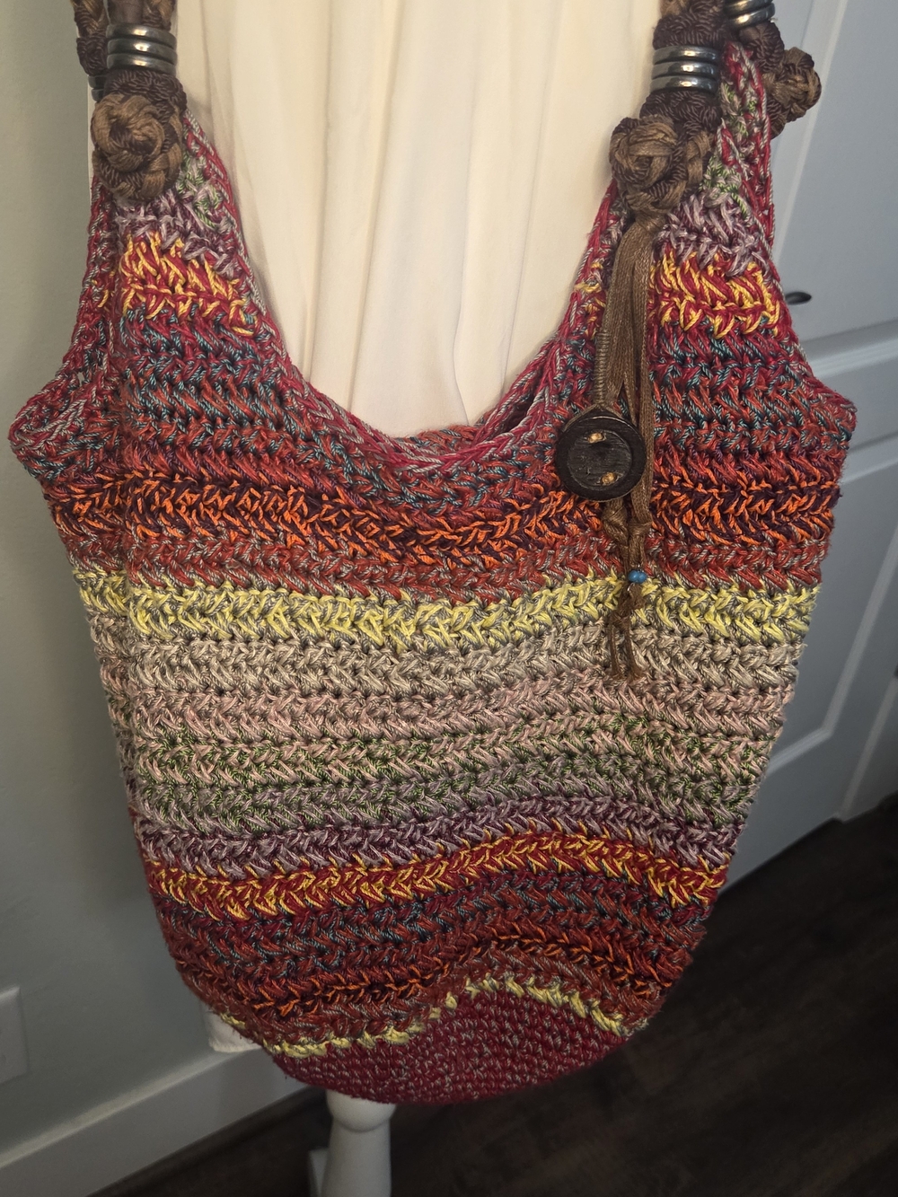 The Sak Handwoven Multicolor Crochet Tote with Brown Leather Tassels.